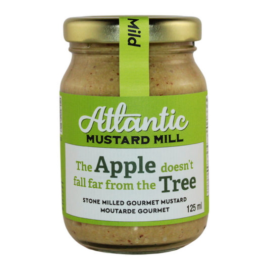 A jar of mustard with apple cider vinegar and fresh apples
